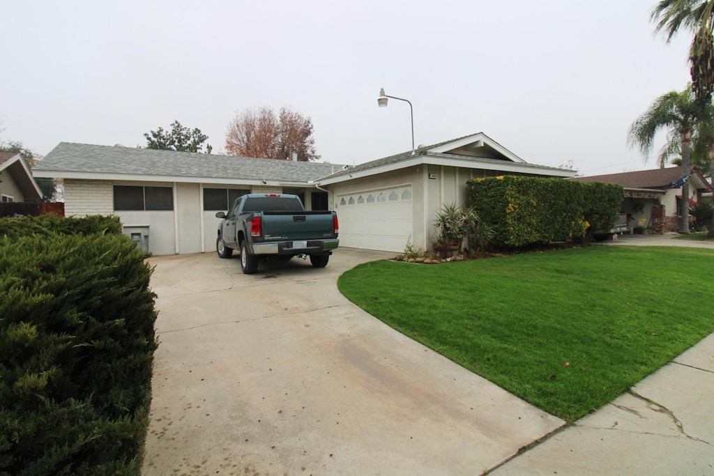 view of front of property with a front yard and a garage