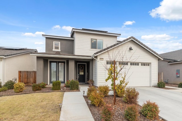 view of front of house featuring a garage and a front lawn