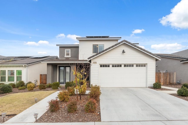 view of front property featuring a front yard, solar panels, and a garage