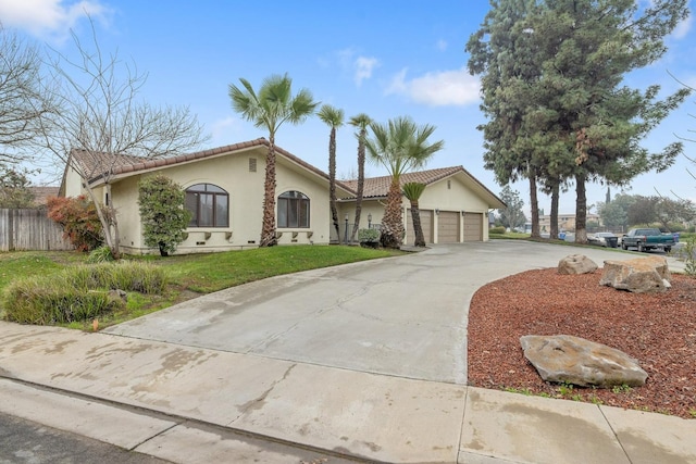 view of front of property with a front yard and a garage