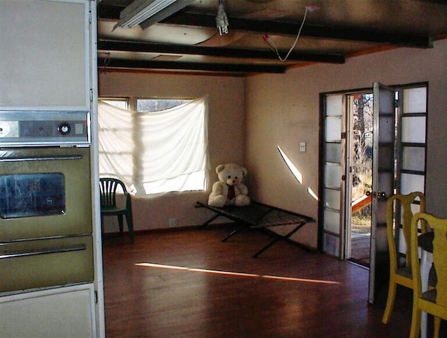 interior space featuring beam ceiling and dark hardwood / wood-style floors