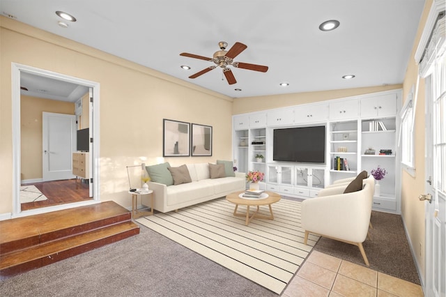 living room featuring crown molding, ceiling fan, and light tile patterned floors