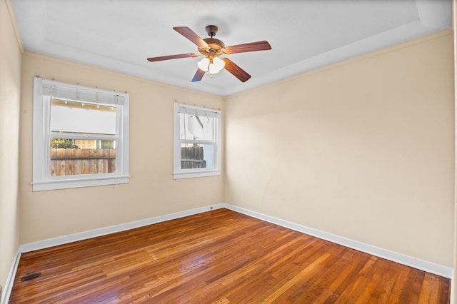 empty room with crown molding, hardwood / wood-style flooring, and ceiling fan