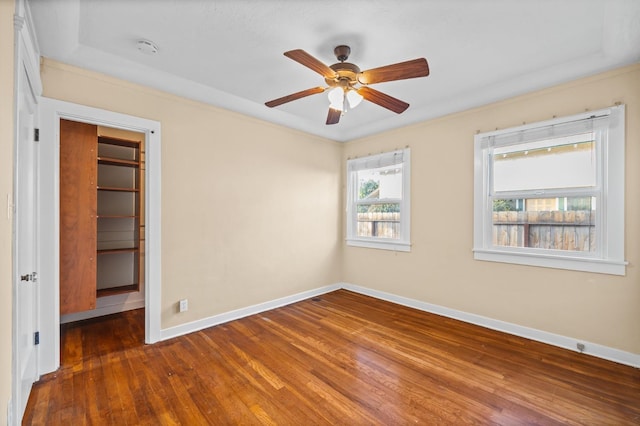 spare room with ornamental molding, dark hardwood / wood-style floors, and ceiling fan