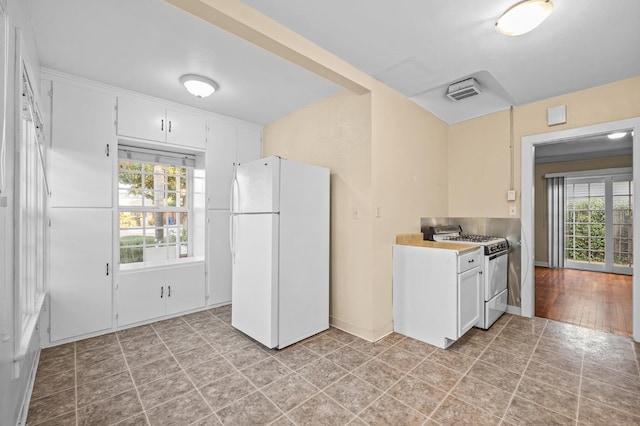 kitchen featuring white cabinets and white appliances