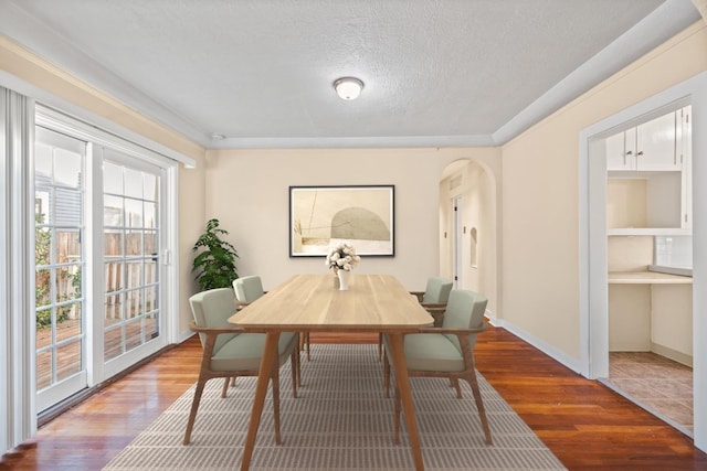 dining room with hardwood / wood-style flooring and a textured ceiling