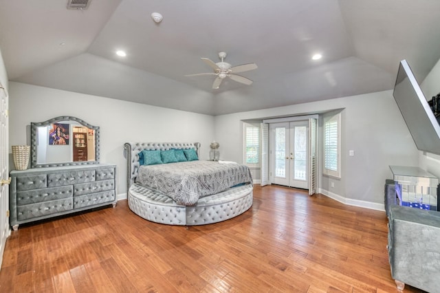 bedroom with french doors, access to outside, vaulted ceiling, ceiling fan, and hardwood / wood-style flooring