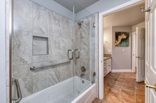 bathroom with shower / bath combination with glass door and vanity