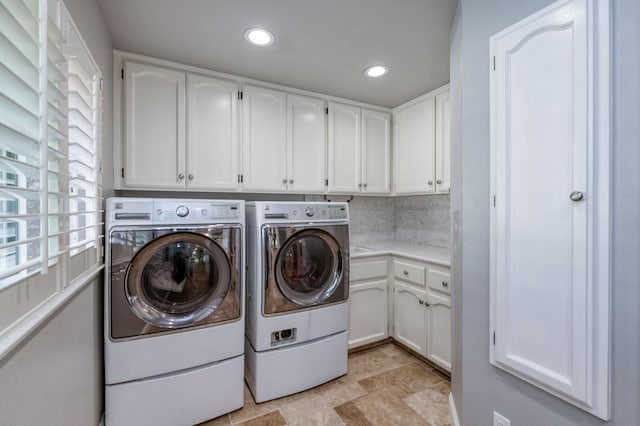 clothes washing area with cabinets and independent washer and dryer