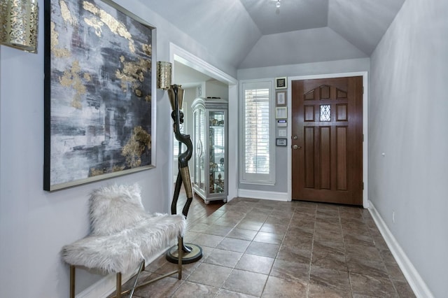 entryway featuring tile patterned floors and lofted ceiling