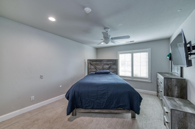 bedroom with light carpet and ceiling fan