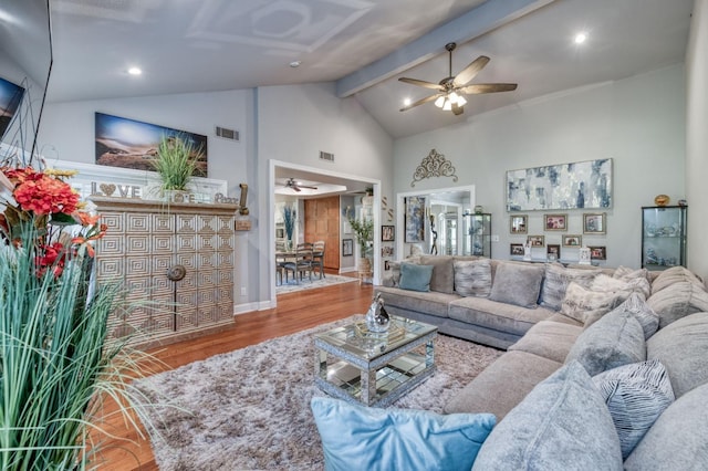 living room with hardwood / wood-style flooring, ceiling fan, beam ceiling, and high vaulted ceiling