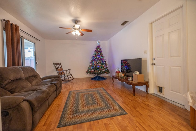 living room with hardwood / wood-style flooring and ceiling fan