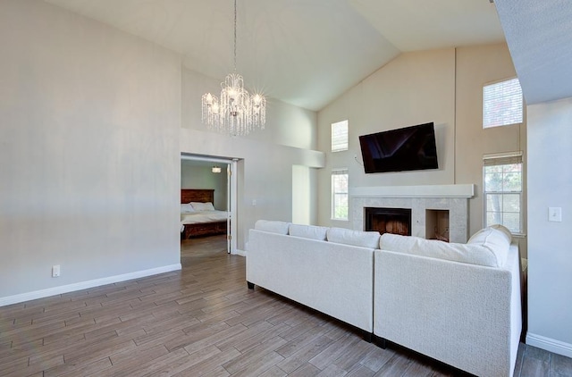 living room with high vaulted ceiling and a chandelier