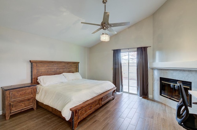 bedroom featuring access to exterior, hardwood / wood-style flooring, vaulted ceiling, and ceiling fan