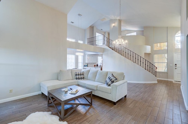 living room with a high ceiling and an inviting chandelier