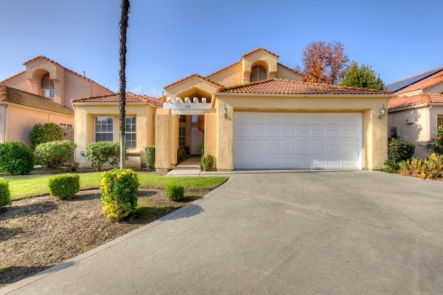 mediterranean / spanish house with a garage