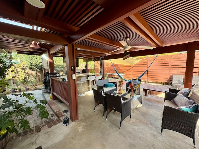 view of patio featuring an outdoor hangout area, an outdoor bar, and ceiling fan