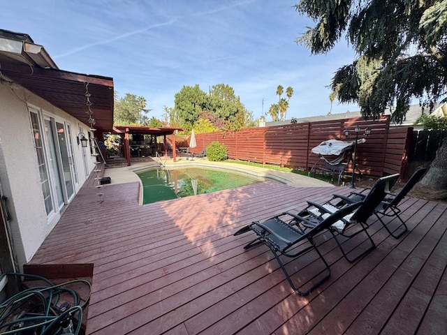 wooden deck featuring a fenced in pool