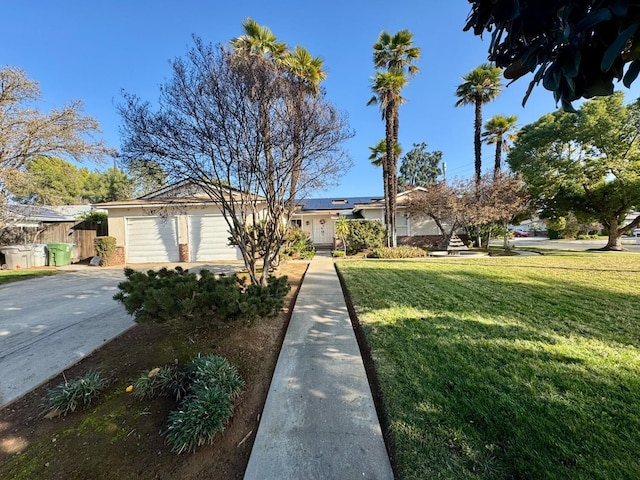 ranch-style house with a front lawn and solar panels