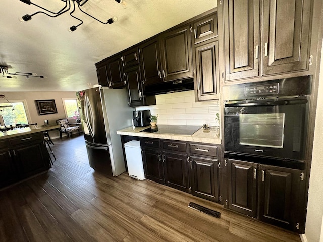 kitchen with tasteful backsplash, dark hardwood / wood-style flooring, black appliances, and dark brown cabinets