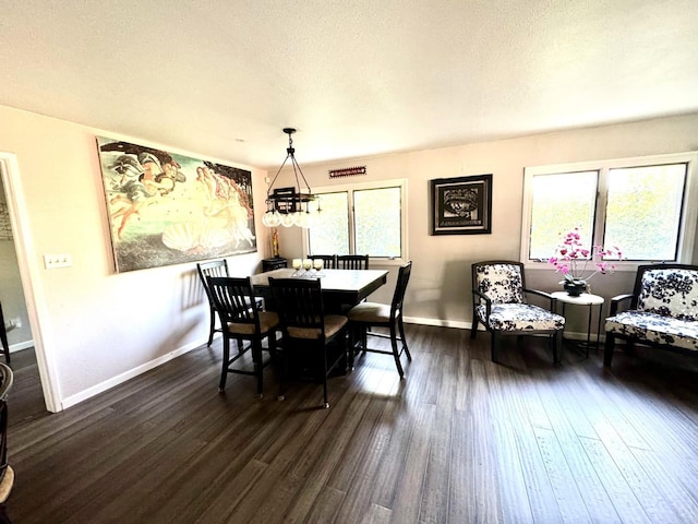 dining space with a notable chandelier, dark hardwood / wood-style flooring, and a textured ceiling