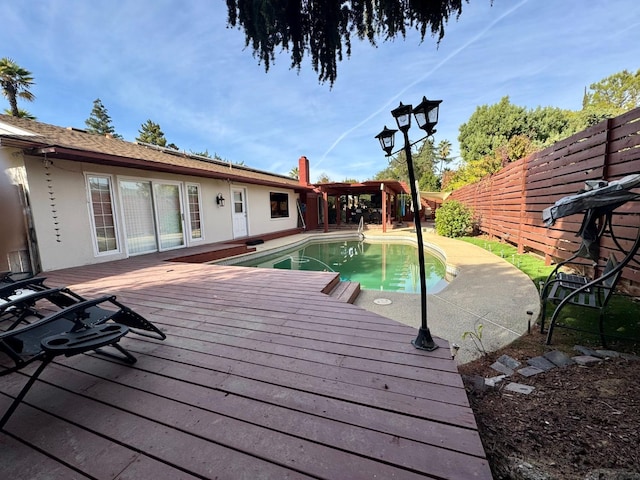 view of swimming pool featuring a wooden deck