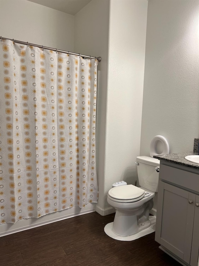 full bathroom with hardwood / wood-style flooring, vanity, toilet, and bathing tub / shower combination