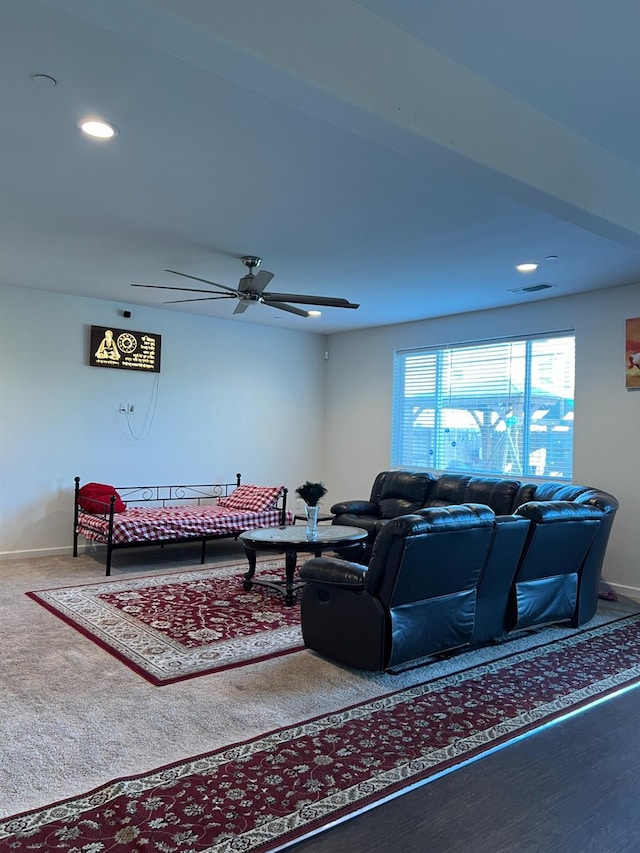 carpeted living room featuring ceiling fan