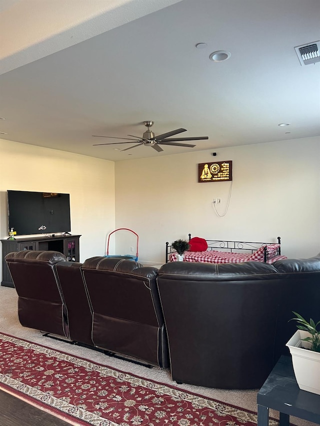 carpeted living room featuring ceiling fan