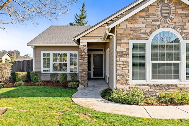 view of exterior entry featuring a lawn