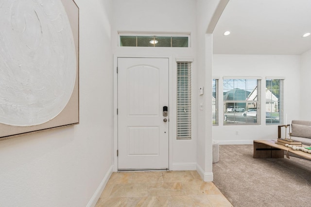 view of carpeted entrance foyer