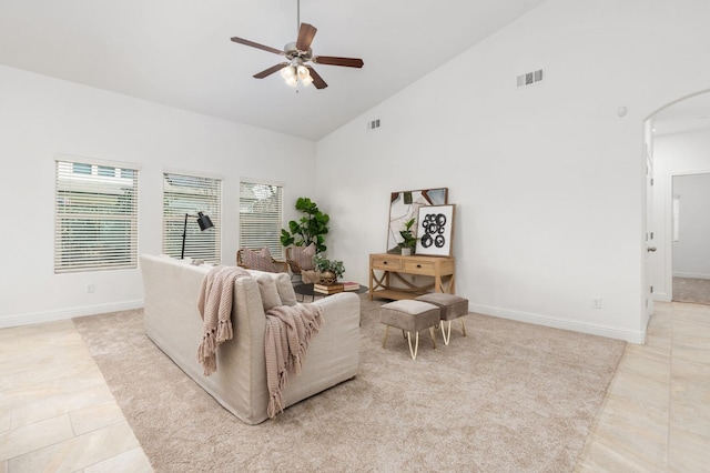 tiled living room with high vaulted ceiling and ceiling fan