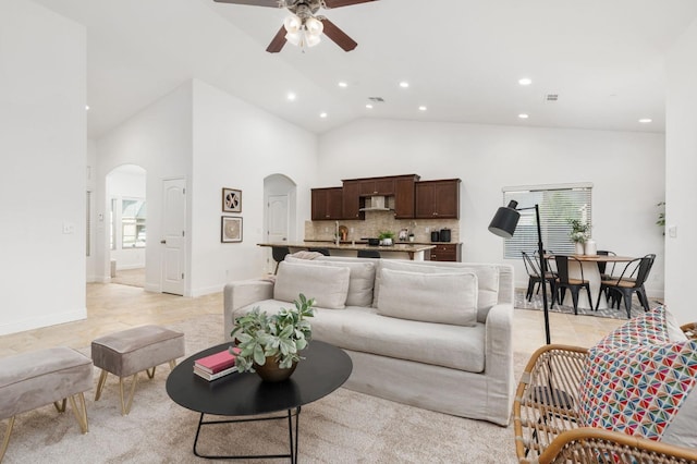 living room with high vaulted ceiling and ceiling fan