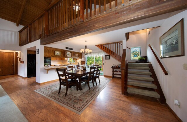 50365 Spook Ln, Oakhurst, CA 93644 - dining space with stairs, baseboards, a towering ceiling, beam ceiling, and wood finished floors