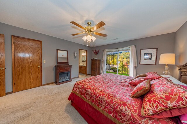 50365 Spook Ln, Oakhurst, CA 93644 - bedroom featuring baseboards, a fireplace, a ceiling fan, access to exterior, and carpet floors