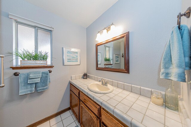 50365 Spook Ln, Oakhurst, CA 93644 - bathroom with baseboards, lofted ceiling, tile patterned floors, and vanity
