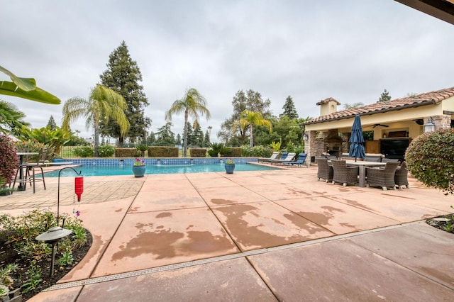 view of pool with ceiling fan and a patio