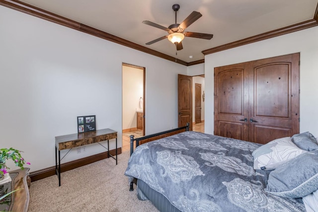 carpeted bedroom with ceiling fan, ornamental molding, connected bathroom, and a closet