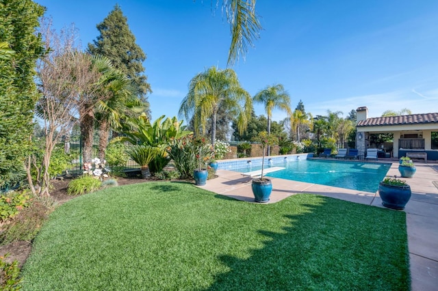 view of pool with a yard and a patio area