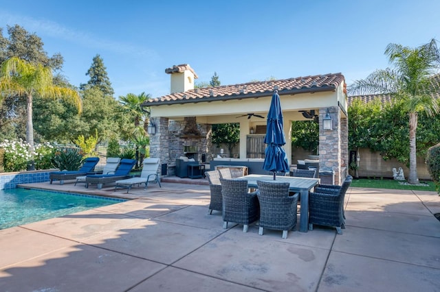 view of patio featuring an outdoor stone fireplace and ceiling fan