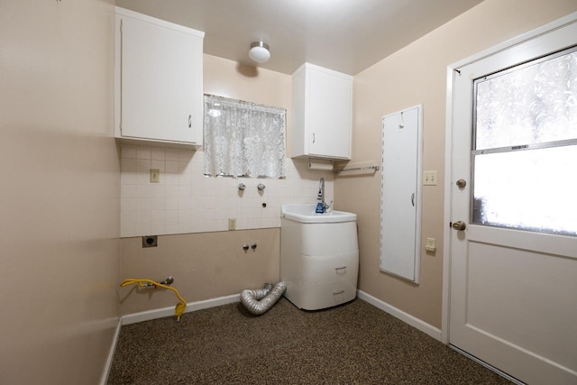 laundry area featuring cabinet space, hookup for an electric dryer, and baseboards