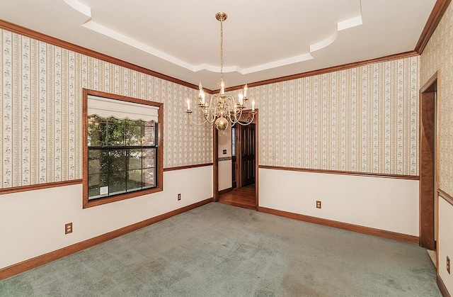 unfurnished room with carpet flooring, a raised ceiling, baseboards, ornamental molding, and a notable chandelier
