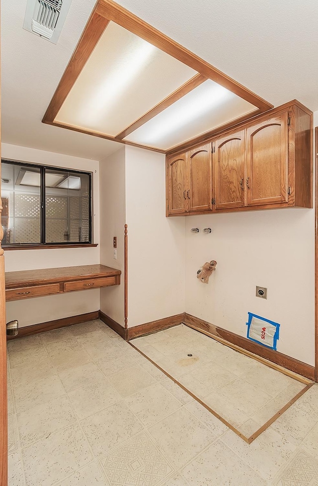 washroom featuring electric dryer hookup, gas dryer hookup, hookup for a washing machine, and cabinets