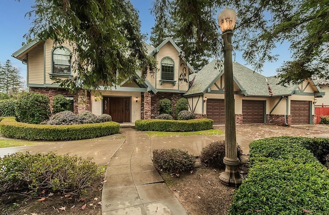 view of front of home featuring brick siding, driveway, and an attached garage