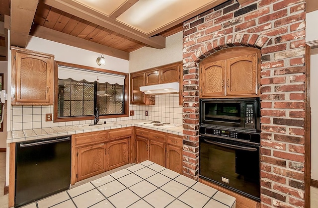 kitchen with tasteful backsplash, black appliances, and tile countertops