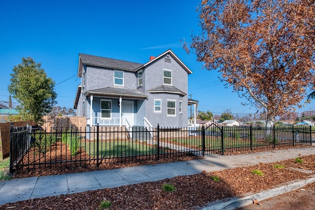 front of property featuring covered porch and a front yard