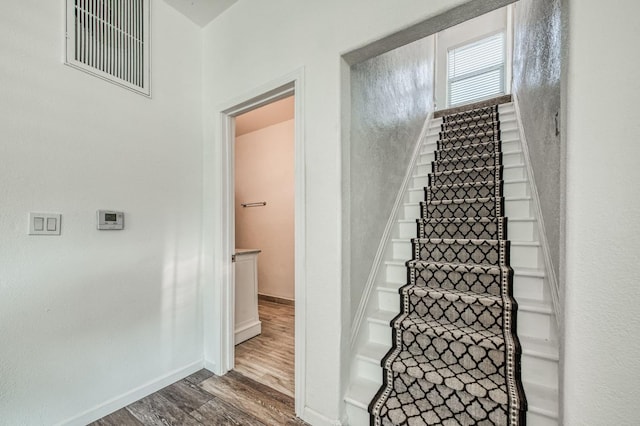 stairway featuring hardwood / wood-style flooring