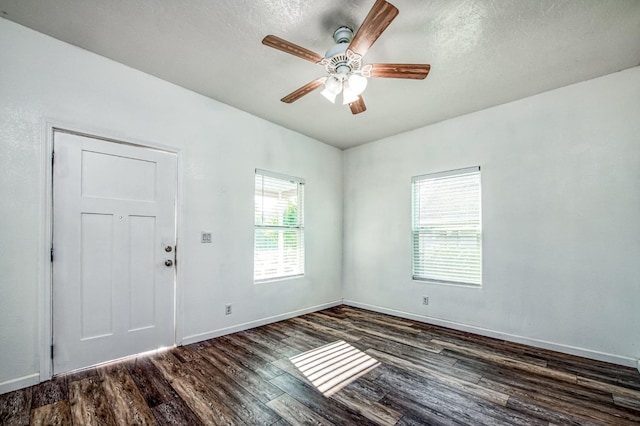 spare room featuring a textured ceiling, dark hardwood / wood-style floors, and ceiling fan