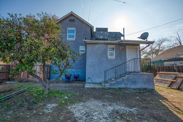 back of property featuring central air condition unit